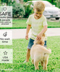 Child playing with dog outdoors, emphasizing safety of Natural Outdoor Pest Control Spray With Essential Oils Kills Mosquitoes Ants Fleas Ticks And More Repels Pests And Keeps Your Yard Safe Around Pets And Kids 32 Oz.