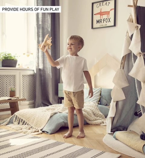 Child playing with Nieuport 17 Wooden Airplane Model Puzzle Kit in a cozy bedroom setting.