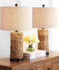 Natural Coastal Water Hyacinth Table Lamp Set Of 2 With Light Grey Linen Shade on wooden table, 25 inch tall