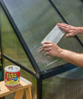 Person applying Thick Rubberized Waterproof Tape That Patches And Seals Leaks Like A Pro Anywhere Underwater Ready Indoor Outdoor Use Great For Roofs Plumbing Pools And RVs Clear 4 In By 5 Ft Pack Of 1 on greenhouse panel