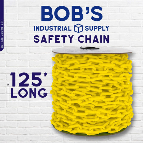 Yellow Plastic Barrier Chain For Safety And Crowd Control, 125 Feet Long And 2 Inches Wide spool against a brick wall backdrop.