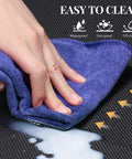 Close-up of purple cloth cleaning spilled liquid on Heavy-Duty Anti-Fatigue Standing Mat 39 By 20 Inches With Safety Yellow Border built for long shifts.