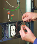 Electrician using Three-Port Push-In Wire Connector for 12-20 AWG Orange 100-Pack in wall socket installation