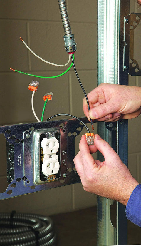 Electrician using Three-Port Push-In Wire Connector for 12-20 AWG Orange 100-Pack in wall socket installation
