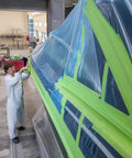 Person applying High Performance Green Masking Tape 401 Plus For Clean Paint Lines, Superior Adhesion, Easy Peel No Residue on vehicle
