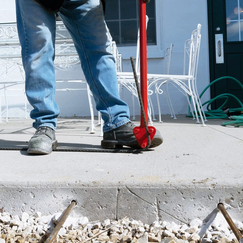 Get your hands on this Marshalltown Qlt Manual Rebar Bender, a 34-inch tool bending rebar on a concrete surface.