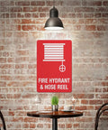 Outdoor Emergency Fire Hydrant And Hose Reel Safety Sign 8x12 inch wall plaque in a rustic cafe setting with red brick wall.