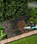 Weed Barrier Fabric Three Point Two Ounce Heavy Duty Ground Cover Four By Two Hundred Feet laid in garden bed with plants