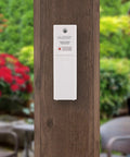 All In One Battery Operated Monochrome Digital Forecast Station sensor mounted outdoors on wood panel