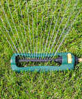 TurboTek Oscillating Sprinkler With 16 Precision Nozzles for Up To 2,800 Sq Ft on lawn, green and yellow design visible
