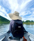 Person wearing 15 Can Capacity Backpack Cooler With Soft Insulated Design Built For On The Go Chill And Road Trip Ready Keeps Ice Up To 24 Hours on a boat