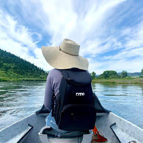 Person wearing 15 Can Capacity Backpack Cooler With Soft Insulated Design Built For On The Go Chill And Road Trip Ready Keeps Ice Up To 24 Hours on a boat