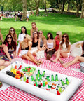 Three-Piece Inflatable Serving Bars Set With Drain Plug And Pump, Ice Cold Bar filled with drinks at a picnic on a red checkered blanket
