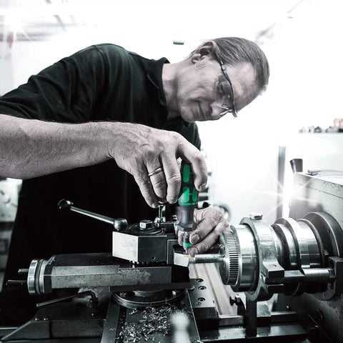 Person using Kraftform Series 7400 Adjustable Torque Screwdriver with Rapidaptor Quick Release Chuck for precise fastening on machinery.