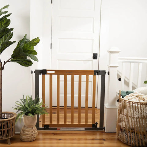 Oak Wood And Metal Baby And Pet Gate For 36 To 60 Inch Openings, 30 Inch Tall, no drill, pressure mount in doorway with plants nearby.