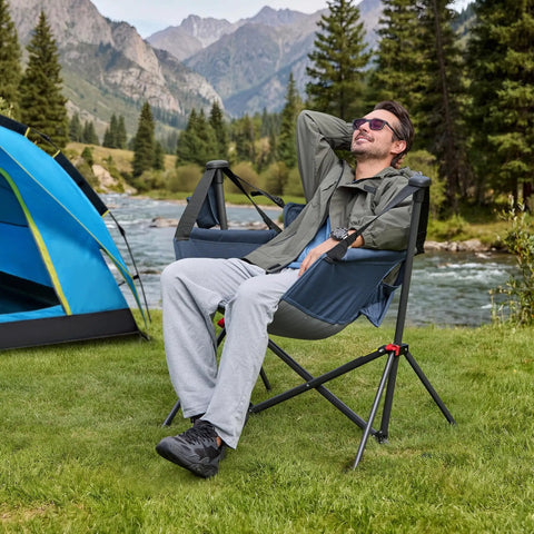 Man relaxing in a Hammock Camping Chair With Adjustable Backrest And Pillow Cup Holder, Heavy Duty 350 Lbs Oversized Swinging Chair by a river.