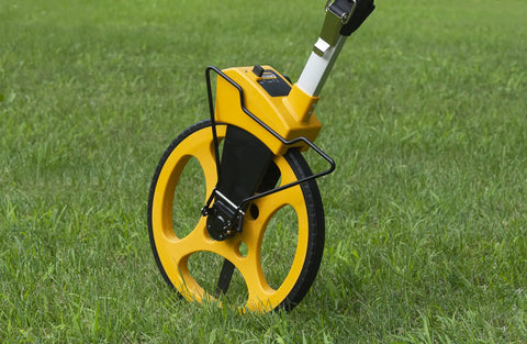 Rugged Pro 12 Inch Diameter Measuring Wheel Measures Up To 10,000 Yards With Brake And Reset Trigger on grass.
