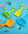 Four tools from Eight Piece Kid Friendly Beach Sand Shovel Set With Colorful Plastic Rakes And Sifters on sand with shells.