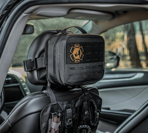 Vehicle IFAK Trauma Kit With CAT Tourniquet, Black Tactical First Aid Kit In MOLLE Pouch mounted on car headrest.