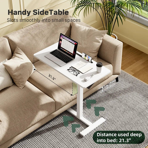 Mobile Standing Desk With Pneumatic Height Adjustment next to couch, with laptop and glasses on white tabletop, depth 21.3 in.
