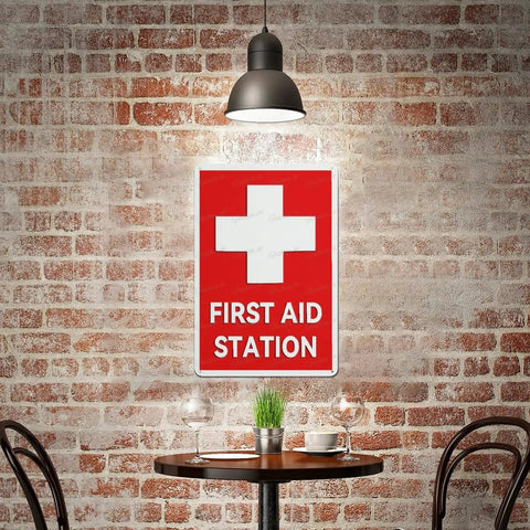 Emergency Medical Facility Sign 8x12 Aluminum Indoor Outdoor Safety Plaque Fade Resistant Wall Marker For Office And Factory Easy Mount Bold Readable Caution Messaging, displayed on a brick wall above a table.