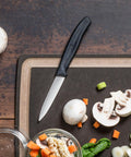 3.25 Inch Paring Knife With Straight Edge Spear Point on cutting board with vegetables