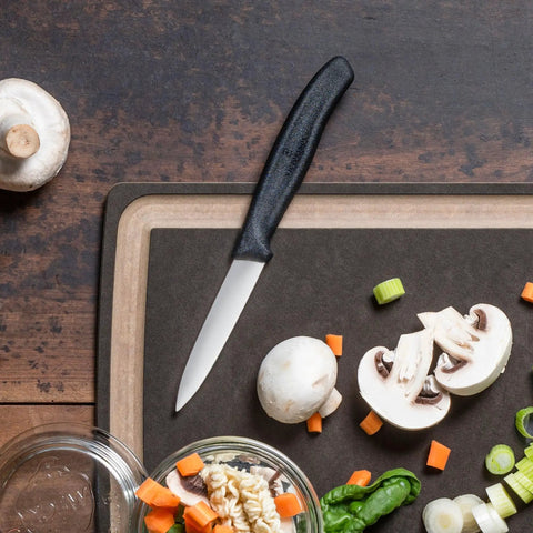 3.25 Inch Paring Knife With Straight Edge Spear Point on cutting board with vegetables