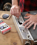 Person using Radiator Repair Kit For Plastic Tank Leak Fix And Permanent Pro Grade Cooling System Repairs With Easy To Follow Instructions