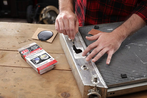 Person using Radiator Repair Kit For Plastic Tank Leak Fix And Permanent Pro Grade Cooling System Repairs With Easy To Follow Instructions