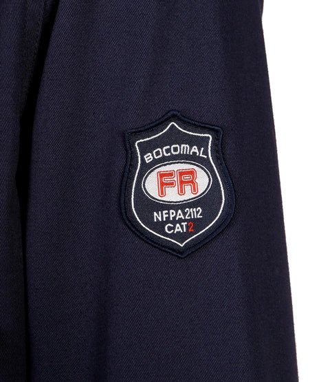 Throw On This Men's Flame Resistant Work Shirt Built From 7.5oz Cotton Twill NFPA 2112 Cat 2 Certified badge detail on shirt.