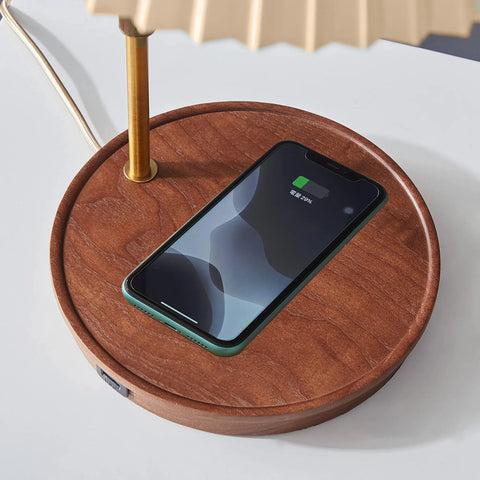 USB Wireless Charging Desk Lamp With Wood And Gold Finish showing phone charging on oak base