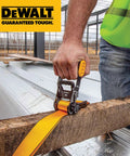 Person using Beefed-Up Mid-Weight Ratchet Tie Down Straps 1.5 Inch By 16 Foot 3300 Pound Break Strength on wooden beam