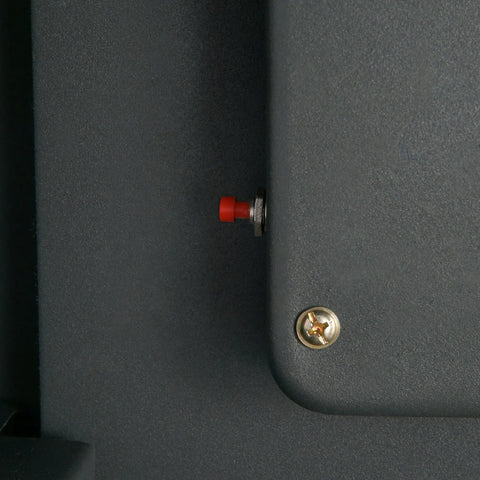 Close-up of locking mechanism on hidden in wall safe with electronic keypad and two manual override keys for security