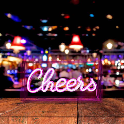 Neon Sign USB LED Light Up Bar Sign For Party Home Decor Desk Lightbox 3D Wall Neon Lamp with lit neon 'Cheers' text in front of bar.