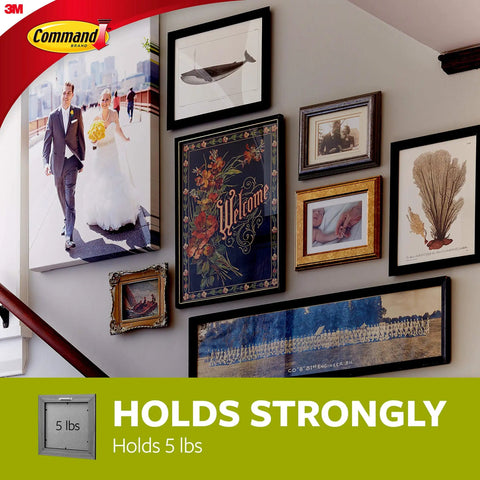 Large Universal Frame Hanger Set With 3 Hangers 6 Strips And 6 Frame Stabilizers For Damage Free Picture Hanging On Walls Doors And Closets 4 Pack Holds Up To 5 Lbs Per Hanger No Holes No Marks Easy To Use displayed on staircase wall with various artworks