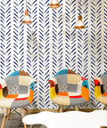 Room with blue and white striped peel and stick wallpaper 17.7in x 394in, vibrant chairs, modern geometric contact paper decor.