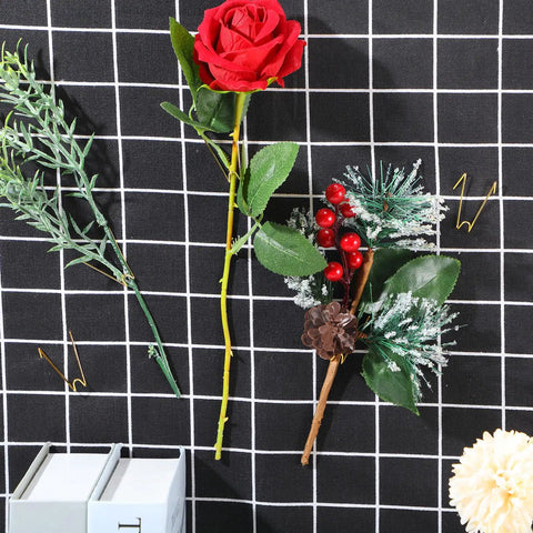 Super Slick Gold Cubicle Hooks For Fabric Partition Walls Tough Stainless Steel Wire Clips holding faux flowers on a grid fabric.