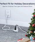 25 Ft 16 AWG Two Prong To Three Outlet Indoor Extension Cord With Tamper Guard powering holiday lights on a Christmas tree