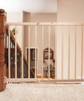 Walk-Through Top Of Stairs Baby Gate In Natural Wood With Four Point Mount, One Hand Release in home setting
