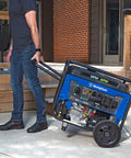 Person moving Dual Fuel Portable Generator With Electric Start And Remote Key Fob, 9500 Peak Watts Gas Or Propane, Transfer Switch Ready, CO Sensor, 7500 Rated Gas Watts, 6750 Propane Watts, Six Point Six Gallon Tank, GFCI 120V Outlets