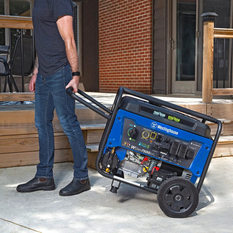 Person moving Dual Fuel Portable Generator With Electric Start And Remote Key Fob, 9500 Peak Watts Gas Or Propane, Transfer Switch Ready, CO Sensor, 7500 Rated Gas Watts, 6750 Propane Watts, Six Point Six Gallon Tank, GFCI 120V Outlets