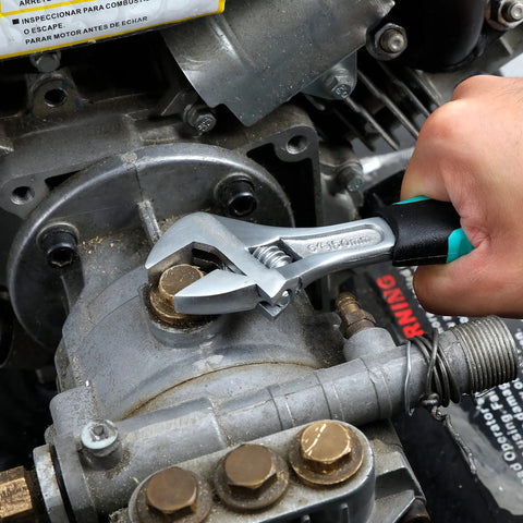 Person using Stubby 4 Piece Tool Set With Hammer Flat And Phillips Screwdrivers And Adjustable Wrench In Turquoise Lightweight Durable Steel With Soft Grip Handles Great For Quick DIY Fixes At Home And On The Go adjustable wrench on machinery
