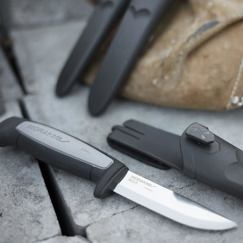 Robust Fixed Blade Knife With Carbon Steel Blade And Combi Sheath, 3.6 Inch Workhorse for Precise Cuts displayed on stone