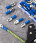 Blue Twenty Pack One Quarter Inch Female Spade Connectors Kit for 22-16 AWG Wire lying on a gray surface, close-up view
