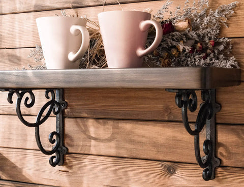 Four Piece Straight Up Heavy Duty Cast Iron Wall Mount Shelf Brackets In Genuine Antique Black with cups and decorations on a wooden shelf.