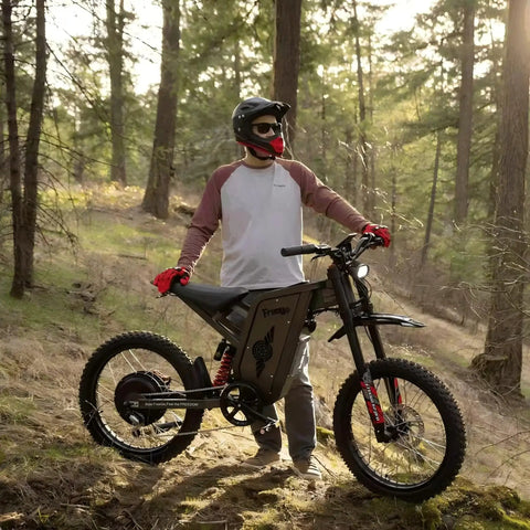 Person outdoors with X2Pro Electric Dirt Bike For Adults With 6000W Peak Motor, 60V/30Ah Battery on forest trail.