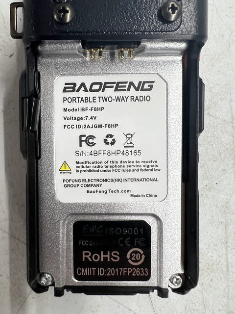 Back of a handheld radio showing model details and certifications, related to 8 Watt Dual Band Handheld Radio Kit With Beefed Up Large Battery Upgrade VHF 136 174 MHz UHF 400 520 MHz Hardened Durable Shell V85 High Gain Antenna Full Accessory Pack Programming Cable Included USA Support