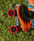 Orange roller skate with "Roller Skate Wheels 92A Red Quad Wheel Replacement For Indoor And Outdoor Use In Speed Skates And Scooter Parts"