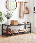 Rock Solid Expandable Shoe Rack Black Two Tier Metal Closet Organizer Holds Eight Pairs Of Sneakers in stylish entryway setting.