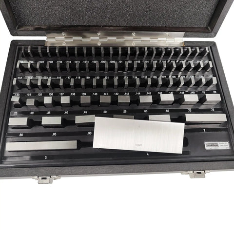 81 Piece Gauge Block Set In Inch Sizes Crafted From Hardened Alloy Tool Steel Built Tough With Dead On Precision Calibration Certified For Serious Machinists And Dimensional Metrology Shops in a protective case showing various sizes.